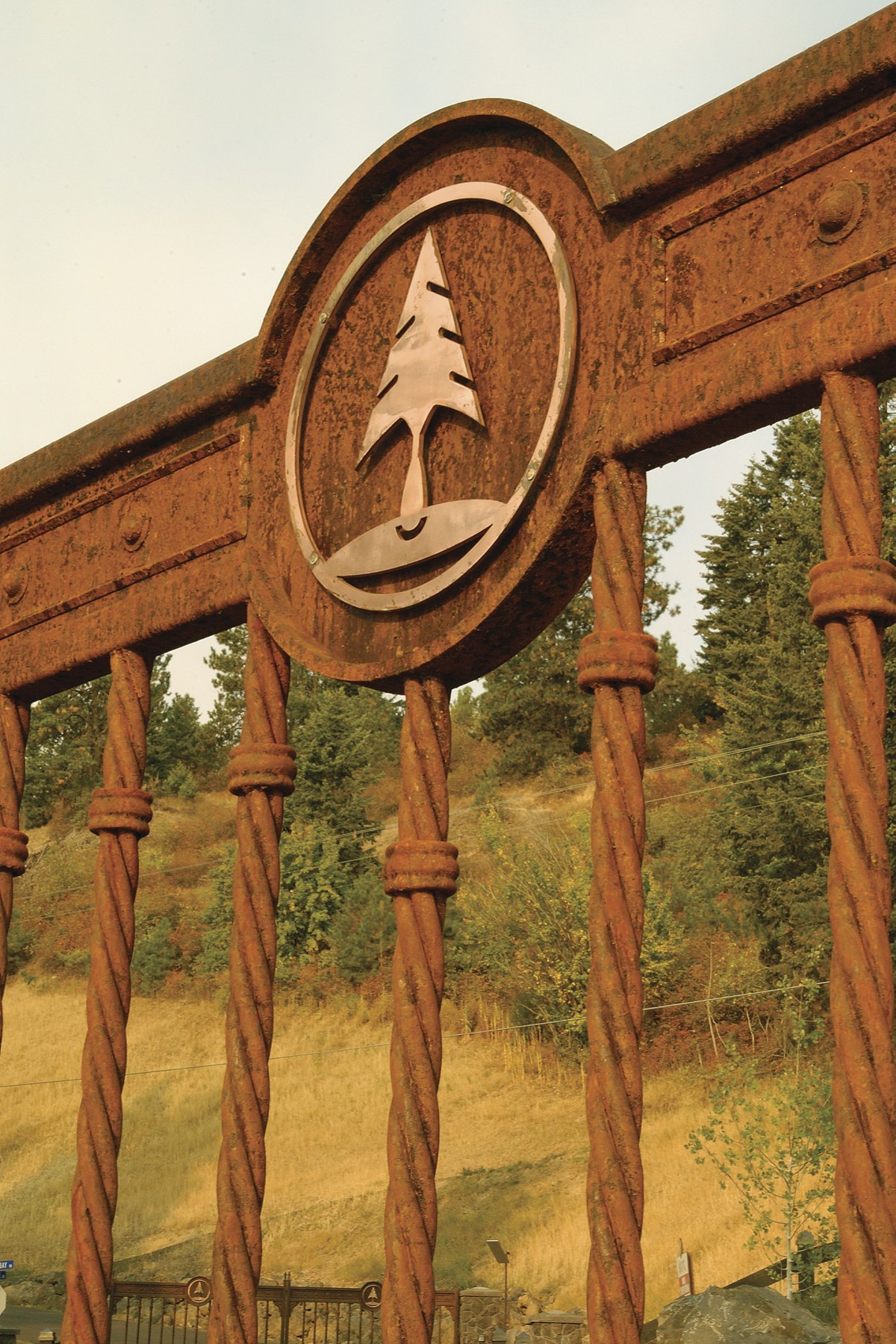 Corten steel gateway with copper tree medallion